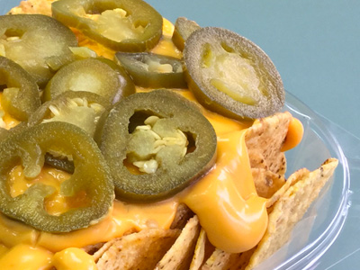 Nachos with melted cheese and jalapenos on top.